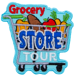 A shopping cart is loaded with food: a pepper, loaf of bread, apple, and carrots. The word Grocery sits above the cart, Store is written on the cart, and Tour rests under the cart but above the wheels.