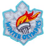 The lit Olympic torch sits on a white snowflake. Winter Olympics is embroidered at the bottom.