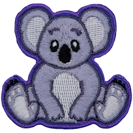 A cute koala bear is sitting down and staring straight ahead.