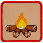 This square badge is part one of a three-part collection that displays a growing campfire. A small yellow flame burns on top of logs in this orange-bordered patch.