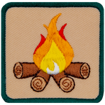 This square badge is part one of a three-part collection that displays a growing campfire. A medium yellow-orange flame burns on top of logs in this green-bordered patch.