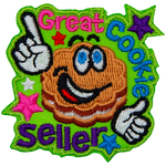 A flower-shaped cookie with frosting in the middle and big, cartoon eyes grins and points to the words Great Cookie Seller.