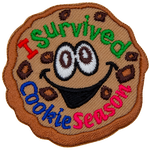 A chocolate chip cookie with wide eyes and a happy smile. The text I Survived Cookie Season is inside the cookie.