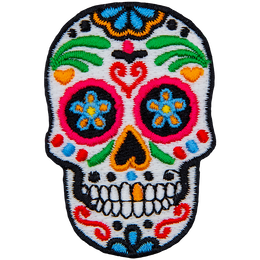 This skull is decorated in a variety of designs and colours, turning it into a sugar skull.
