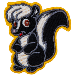 This adorable skunk is sitting on its hind legs with its forelegs tucked against its belly.