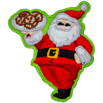 Santa Clause proudly holds up a tray of cookies and gives a big jolly smile.