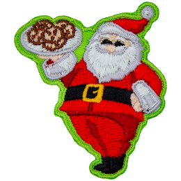 Santa Clause proudly holds up a tray of cookies and gives a big jolly smile.