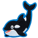 An orca whale smiles and arches its tale up towards the sky.