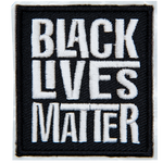 A black rectangle has the words Black Lives Matter embroidered in grey thread. Each word is stacked on top of the next.