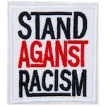 A white rectangle has the words Stand Against Racism embroidered in black, red, and black thread, respectively. Each word is stacked on top of the next.