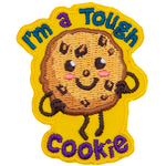 A chocolate chip cookie has a kawaii face. It proudly stands with its hands on its hips. Surrounding it are the words I'm a Tough Cookie.