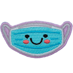 A blue mask has a kawaii face consisting of two black dots for its eyes; a big U forms a smile, and pink blush colours the mask's cheeks.