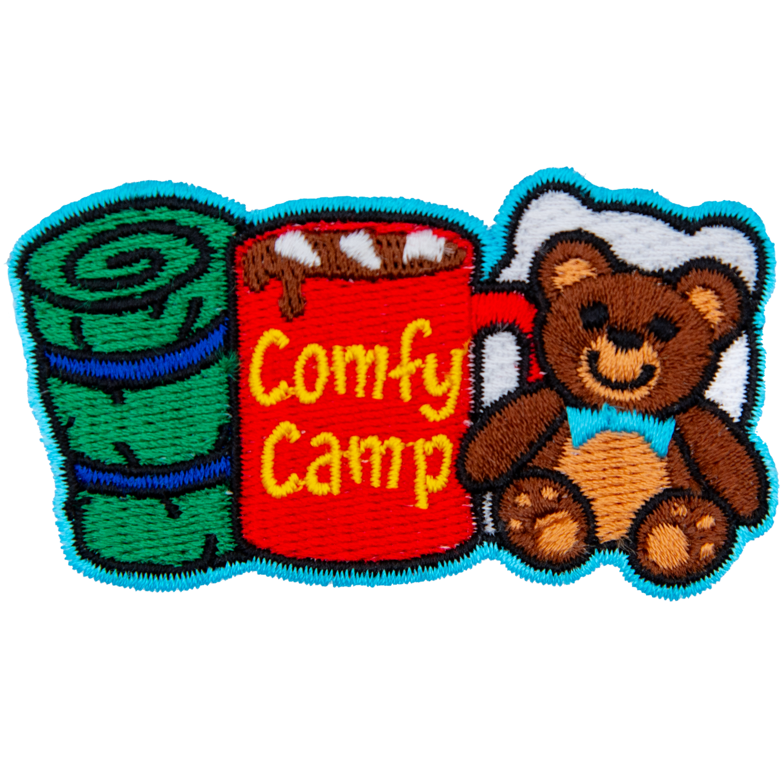 From left to right is a sleeping bag, a mug of coco with the words 'Comfy Camping' on the side, and a teddy bear with a pillow behind it.