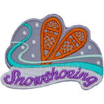 A pair of wooden snowshoes are on a background of snow and wind. The word Snowshoeing is embroidered across the bottom.