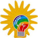 A rainbow-filled light bulb has a starburst behind it.