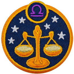 This circular crest displays the scales of justice surrounded by stars. The sign of Libra sits above it.