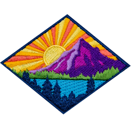 This diamond-shaped badge depicts a sun rising behind a mountain. The sun casts its rays over a lake surrounded by a forest.