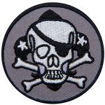 This pirate skull wears an eye patch on its left eye. The skull has two crossed bones and a fleur-de-lis behind it.