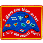 A camp blanket covered in patches, crests, and badges. The text reads, I didn't sew them on, but I sure can collect them!