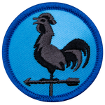 A metal rooster sits on an arrow, forming a weather vane. 