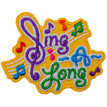 The words Sing A Long with music bars and notes in the background. The S in Sing is a backwards treble-clef.