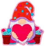 A gnome holds a big heart, and potted heart flowers stand to either side of him.