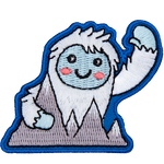 This happy yeti waves a warm welcome as they hold onto the Himalayan Mountains.