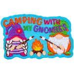 Two gnomes are out camping and roasting marshmallows over a roaring campfire.