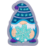 A gnome wearing a blue toque holding a snowflake.