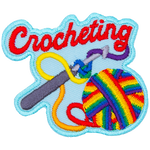 A ball of rainbow yarn is twisted around a crochet hook. The word Crocheting is across the top.