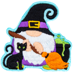 A gnome dressed as a witch holds a broom next to a black cat and a bubbling cauldron.