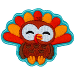 An adorable turkey faces the viewer.