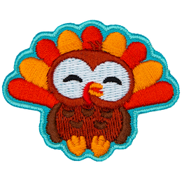 An adorable turkey faces the viewer.