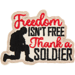 A soldier kneels next to the words Freedom Isn't Free Thank A Soldier.