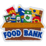 A cardboard box with cans of food inside and the words Food Bank on the side.