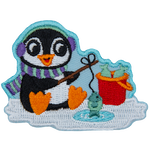 A little penguin in winter gear sits on the ice, fishing.