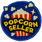 A bucket of popcorn with the words Popcorn Seller on the front.