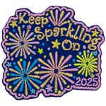 The words Keep Sparkling On are surrounded by pink, gold and blue fireworks.