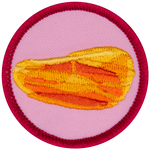 An amber gemstone on a pink background.