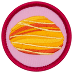 A fire opal is in the centre of a circular pink badge.