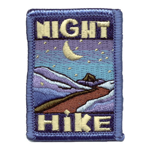 The words Night Hike frame the top and bottom of this patch. In the middle is a mountain trail underneath a starry night sky.