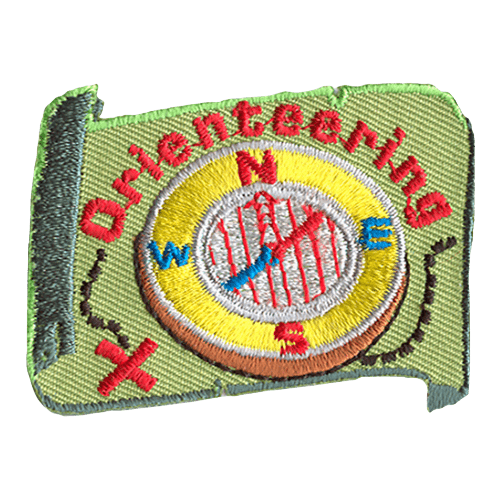 A green map forms the background of this patch, and the word Orienteering arches over a compass. A black dotted line is drawn on the map leading to a red X.