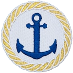 A two pronged, barbed nautical anchor is in the center of this circular crest. A braided rope made of gold thread is embroidered around the edge as a border.