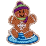 A gingerbread person skates on ice with a pink and green hat and scarf.
