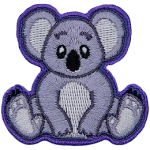 A cute koala bear is sitting down and staring straight ahead.