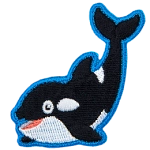 An orca whale smiles and arches its tale up towards the sky.