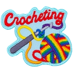 A ball of rainbow yarn is twisted around a crochet hook. The word Crocheting is across the top.