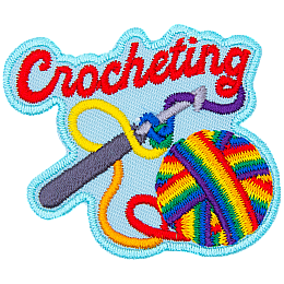 A ball of rainbow yarn is twisted around a crochet hook. The word Crocheting is across the top.