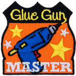 This achievement badge showcases a glue gun surrounded by gold stars.