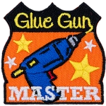 This achievement badge showcases a glue gun surrounded by gold stars.